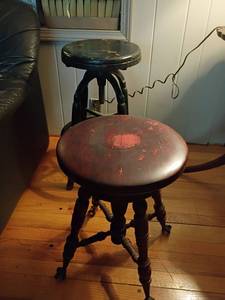 lot 967 image: 2 Vintage Wooden Bar Stools with Adjustable Seats.  One I believe is a piano stool.   It has the claw feet. See pictures 19 x 14 and 25 x 13.  Both need paint