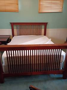 lot 987 image: Mission Style Queen Sized Bed.  Mattress and Box Springs.  Temper Pedic.  Headboard 48 x 69 x 5.   Footboard 36 x 69 x 5.  Mattress has cover on it