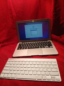 lot 1120 image: Apple MacBook Air Laptop with Wireless Keyboard and protective case