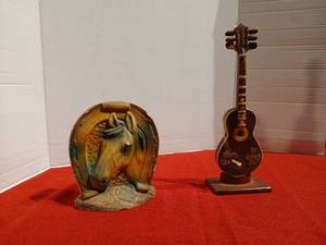 lot 1172 image: Vintage Chalkware horse head Figurine framed by a lucky horseshoe, 6 inches tall, a few chips,  vintage  wooden guitar-shaped on stand, loose guitar strings needs glued