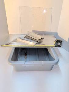 lot 1484 image: Metal scraps and chipped acrylic in a plastic bus tote