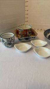 lot 1951 image: Asian Porcelain Pieces Bowls Cup Saucers Dishes and an antiqued ivory-colored resin Green Tara tsa tsa (miniature Buddhist devotional relief plaque)