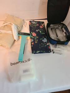 lot 2123 image: Plastic syringes, bearback lotion applicator, heating pad, cosmetics bag
