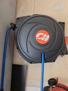lot 4006 image: Retractable Air Hose Reel with Blue Hose Wall-Mount, bring tools to remove from garage wall