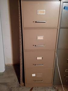 lot 3202 image: Metal Filing Cabinet.   4 Drawers    52 x 18 x 28.  Located in basement