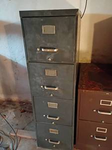 lot 3210 image: Metal Filing Cabinet.  4 Drawers.  52 x 15 x 28.    Located in basement