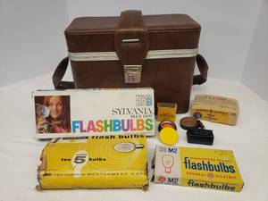 lot 36 image: Vintage Camera TravelStorage Case, Vintage Kodak Dayligh Filter in Original Box, Bulb Case, Leather Strap, and 4 boxes of Vintage Flash Bulbs G.E., Adams, & Sylvania