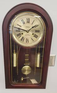 lot 60 image: Vintage Waltham 31 Day Chime Pendulum Wall Clock with Brushed Gold Face, Weights, & Pendulam Medallion - Roman Numerals on Face - Dome Top Wood Casket Style Case with Gold Trimmed Glass Door - Includes 2 WindingAdjutment Keys - 12.5in W x 6in D x 24in T