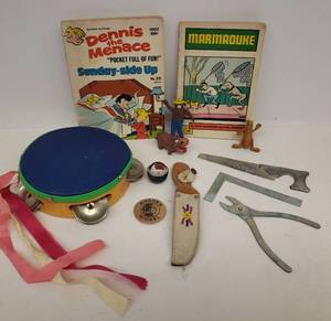 lot 94 image: Vintage 1970 MARMADUKE Comic Book, 1975 Dennis the Menace Comic Book, Old Character Toys, Metal Play Tools, Beaded Leather Knife Sheath, ND Wooden Nickel, and Bamboo Tamborine
