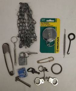 lot 96 image: NIP Key Retriever, Dog Chain, Antique Clarks Spats Button Hook, Old Laundry Pins, Handcuff Key Chain, Padlock wKey, Keychain Tools, and Mini Skeleton Key