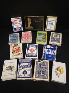 lot 111 image: 12 Packs of Playing Cards - 3 still SealedUnopened, 1 pack of Kansas Sunflower State Playing Cards in Case, and 1948 Old Faithful Bridge Pack of Playing Cards in Original Box