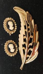 lot 122 image: Vintage CORO Signed IvoryBlack Cameo Screw Back Earrings in Gold Tone Settings 78in T, and SignedStamped Gold Tone Metal Leaf Brooch 2.75in L