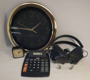 lot 135 image: Large Button Electronic Calculator, Ingram Quartz 11.5in Round Wall Clock with Gold Frame, Set of Telex #510 Sound System Headphones, and Lifelong Quartz Mini Travel Alarm Clock