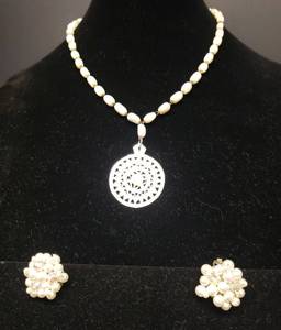 lot 136 image: Vintage Carved Mother of Pearl Mandala Design Pendant on Mother of Pearl Oval Bead 20in Necklace, and Set of 1950s Faux Pearl & Arora Borealis Bead Clip Earrings