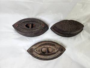 lot 164 image: 3 Cast Iron Sad Iron Rests with Decorative Markings Taylor Forbes Asbestos
