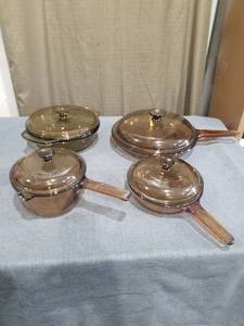 lot 2072 image: Four-Piece Amber Glass Cookware Set with Lids and Handles