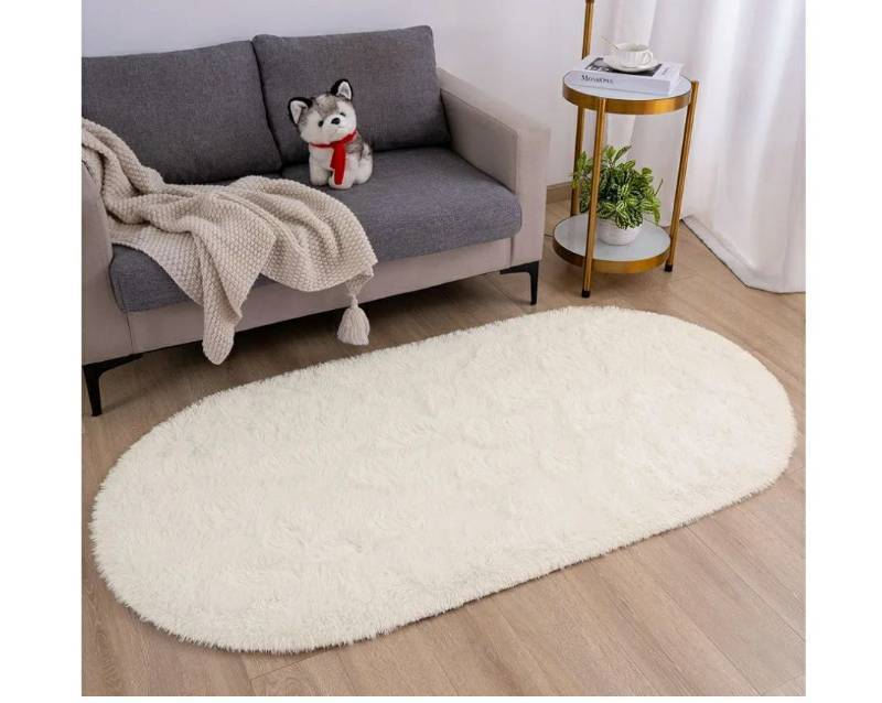 lot 46909 image: Fluffy Bedroom Rug, Small Oval Area Rugs, Cream Shag Bedside Carpet for Kids Room Nursery Dorm Cute Fuzzy Indoor Decor for Boy and Girl, 2.6 x 5.3 Feet. - Retail $22