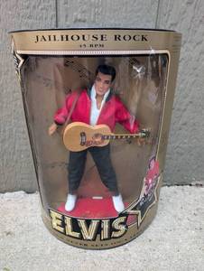lot 561 image: Elvis Jailhouse Rock 45 RPM 12 Inch Doll with Guitar and Stand