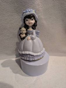 lot 1504 image: Ceramic Music Box Figurine Girl with Teddy Bear