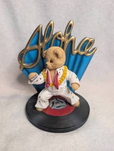 lot 4501 image: Bear Figurine Elvis-Style White Jumpsuit Blue Hand Backdrop