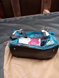 lot 33736 image: Anna by Anuschka hand-painted leather handbag featuring the blue-and-teal Denim Paisley Floral artwork.