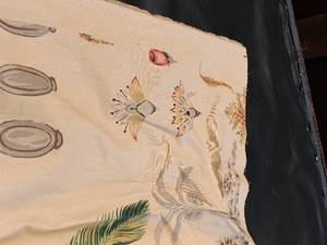 lot 33662 image: Light cream-colored tablecloth featuring delicate, colorful botanical and insect illustrations printed across the fabric