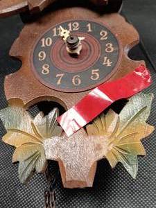 lot 33672 image: Hand-carved wooden cuckoo clock with a traditional Black Forest style with carved leaf accents and bird motifs