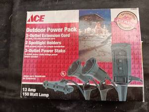 lot 33801 image: Ace Outdoor Power Pack box that contains an outdoor electrical set with a power stake, extension cord, and spotlight fixtures.