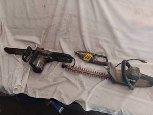 lot 33820 image: Three outdoor yard tools a Worx electric sawtrimmer, a small handheld trimmer, and a Black & Decker corded electric hedge trimmer.