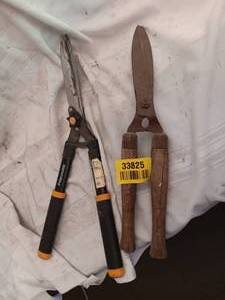 lot 33825 image: Two manual garden hedge shears one pair with black and orange cushioned grips, one with traditional wooden handles.