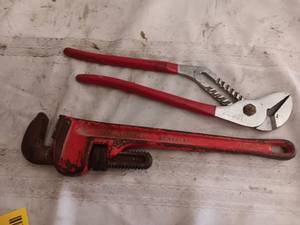 lot 33832 image: Adjustable pipe wrench and a pair of tongue-and-groove pliers