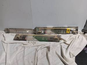 Set of two packaged brass or gold-toned metal towel bars, wall-mounted bathroom hardware.