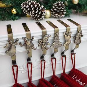 lot 73620 image: Christmas Stocking Holder for Mantle Set of 6, Reusable Christmas Stocking Hooks, No-Damage Xmas Hanger for Fireplace mantle Grip Stand Christmas Decoration Ornaments Hanging Bronze Shelf Floor - Retail $27