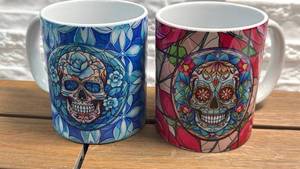 lot 56 image: Pair of Ceramic Mugs with Skull Floral Stained Glass Design