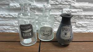 lot 317 image: 3-Piece Glass Potion Bottle Lot - Feather of the Raven, Bone Powder, Spider Fangs