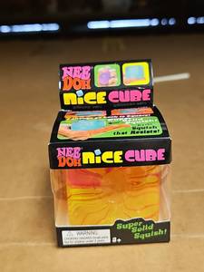 lot 63969 image: NeeDoh Nice Cube Sensory Toy - YellowRed Swirl
