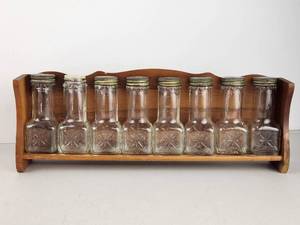 lot 100 image: Vintage 8-Piece Glass Spice Jar Set with Wood Wall Rack and Metal Lids