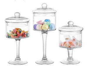 lot 47101 image: 3 Piece Glass Apothecary Jar Set with Lids Candy Storage Jars. NEEDS TO BE WASHED. - Retail $60