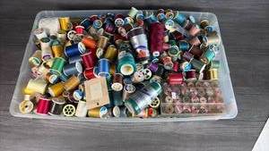 lot 148 image: Large Lot Sewing Thread Spools Multiple Colors in Clear Storage Container