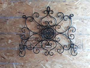 lot 126 image: Scrolled Metal Wall Decor with Ornamental Center MedallionCandleabra