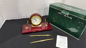 lot 1050 image: Howard Miller clock with pen and pencil set