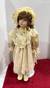 lot 1100 image: Porcelain doll approx 26 inches tall with stand