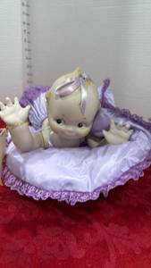 lot 1104 image: Kewpie porcelain doll on pillow