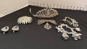 lot 1210 image: Womens jewelry tiara, pins, charm bracelets and clip on earrings