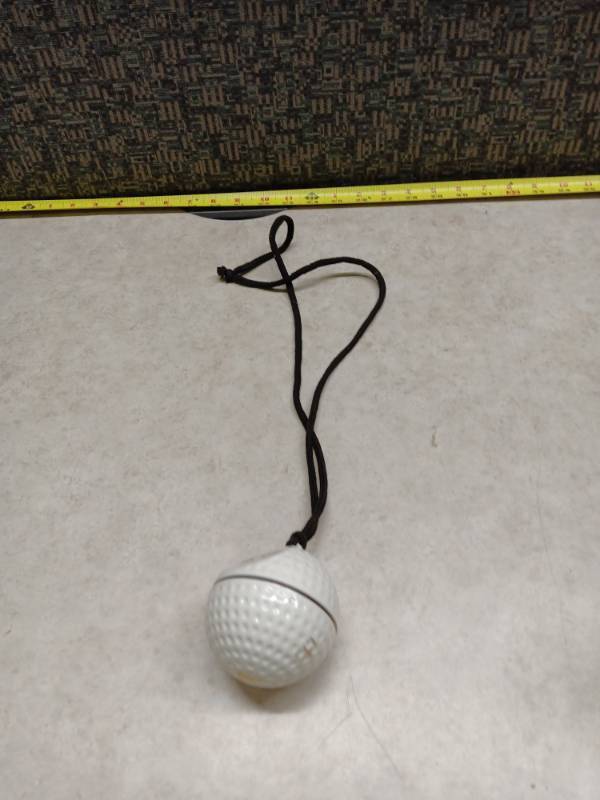 lot 1166 image: Closter Golf White Golf Ball w Black Cord Lanyard