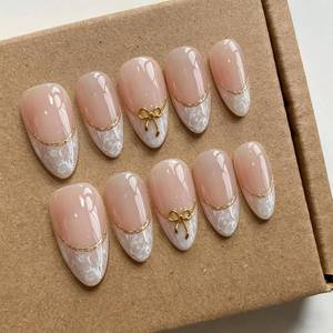 lot 486 image: Handmade Acrylic Press on Nails Medium Almond, Nude French Tip Fake Nails with Gold Bow, Glossy Reusable ABS Hand Painted Glue on False Nails, Elegant Nail Designs(M) - Retail $13