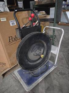 lot 259 image: Heavy duty steel and plastic Banding cart with clamping tools. Cart it is sitting on is NOT included.