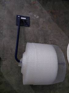 lot 73 image: Roll of bubble wrap with wall mount