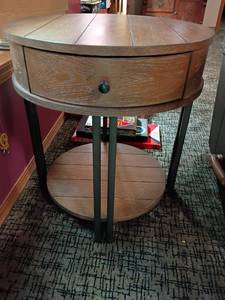 lot 906 image: Round Side Table with a Drawer and Bottom Shelf.  24 x 22.  Located in basement