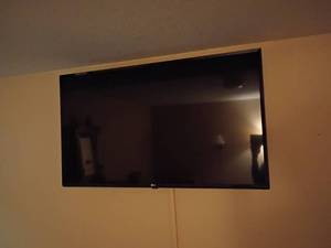 lot 928 image: 42in LG Television. Still on wall.  Will need to bring tools to remove this item